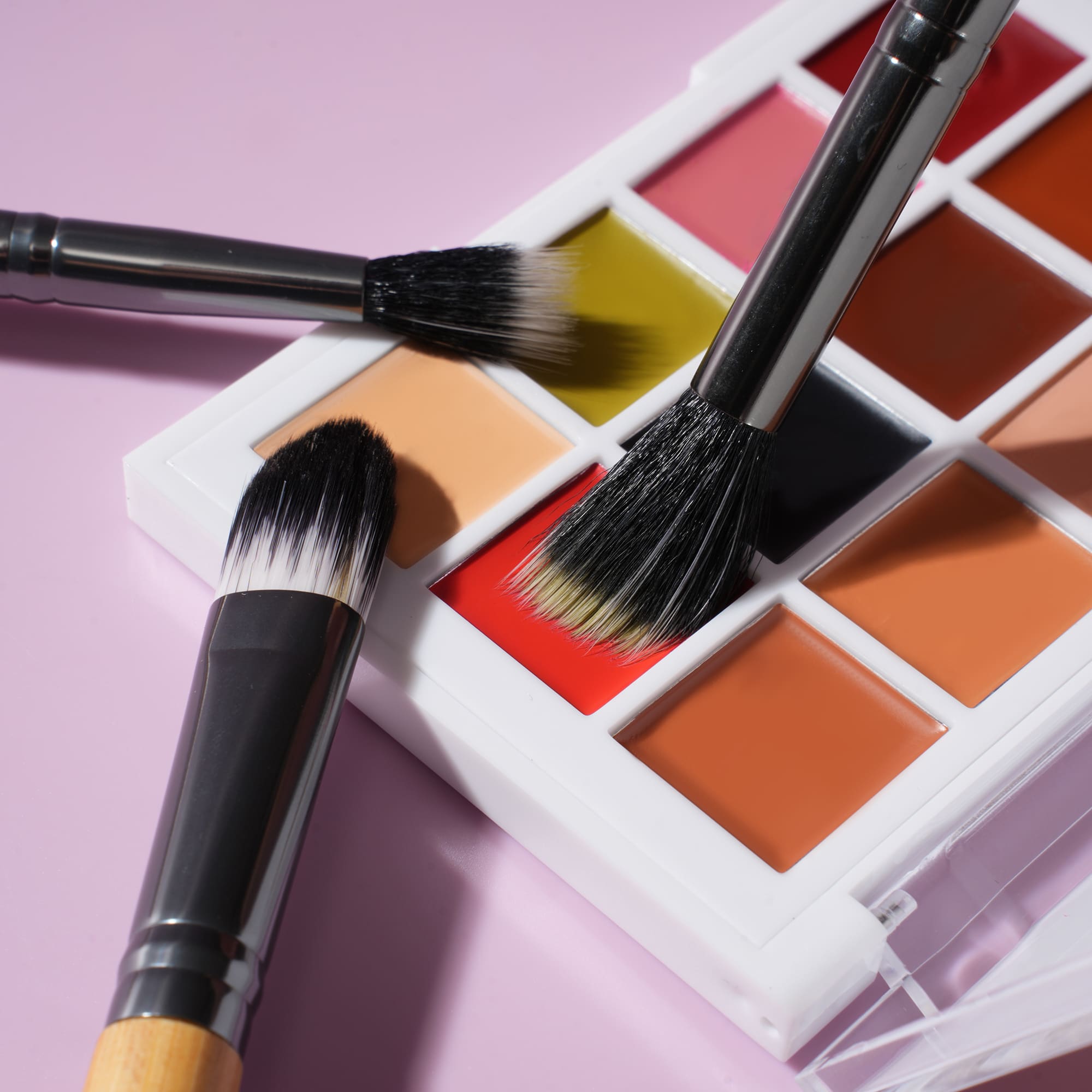 Quick-Set Cream Palette with applicator brushes on lavender background