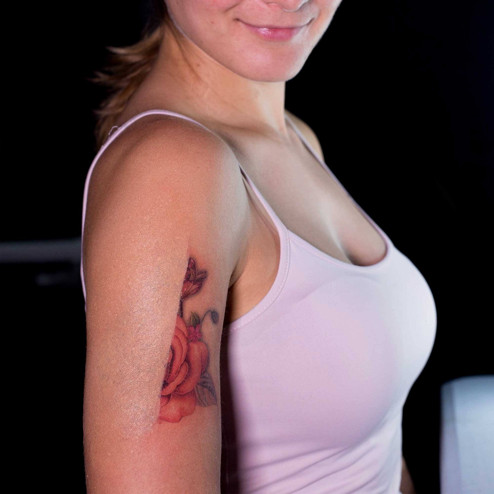 Model showing tattoo cover-up result on upper arm