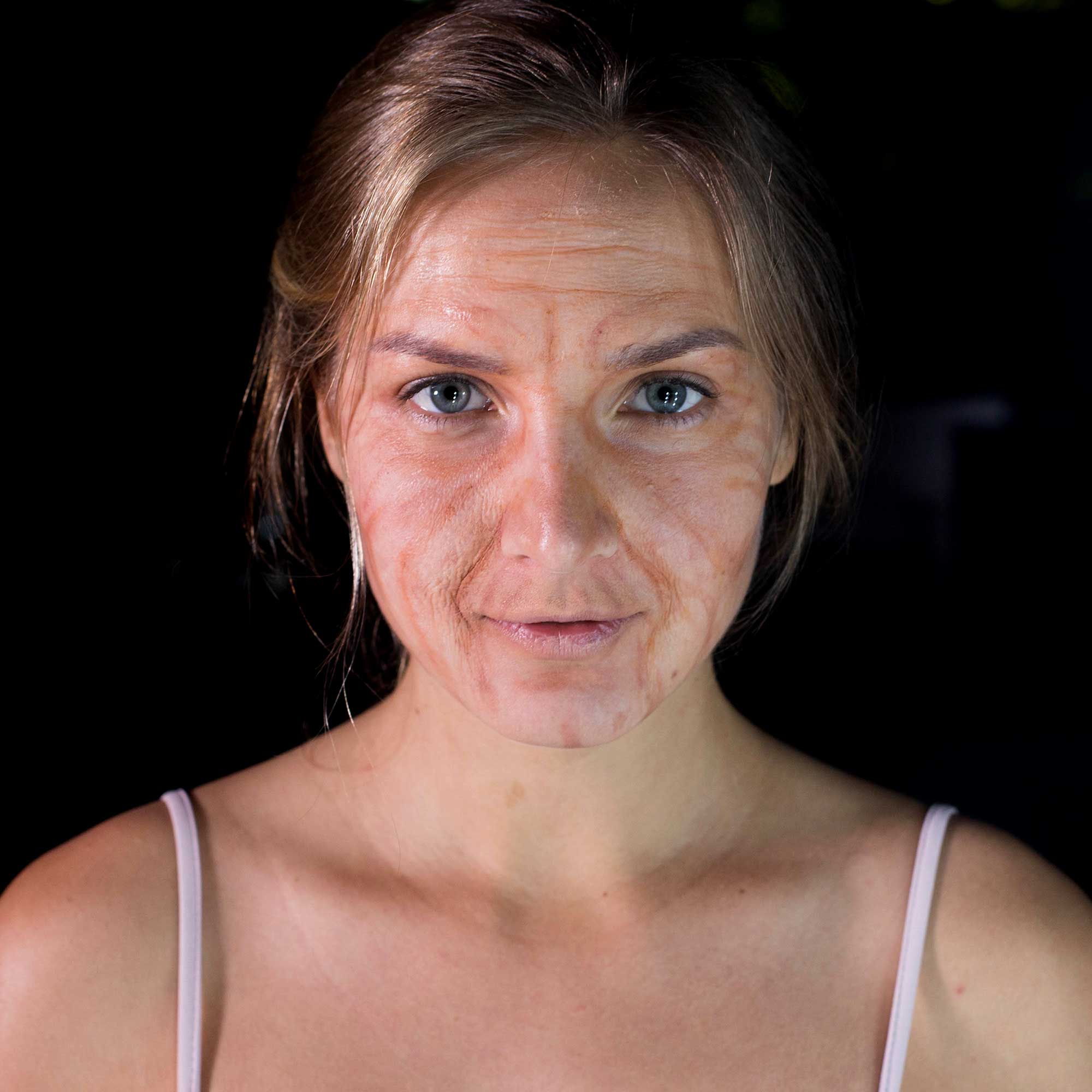 Close-up portrait showing realistic aged makeup result created with flesh tone palette
